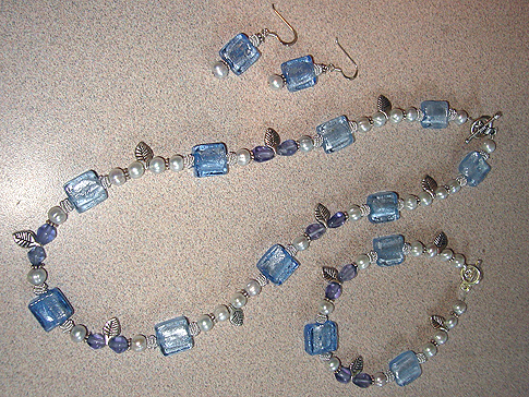 Lavender Fresh Water Pearls, Blue square Lamp beads, Amethysts, & Sterling catch & leaves. Necklace $60.00 Bracelet $30.00 Earrings $18.00 SOLD