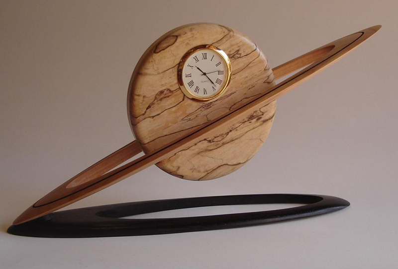 Large Saturn Clock -13" long x 7" high x 3" deep - Spalted Maple disc, Cherry ring, Ebonized Walnut base.  Small version - 7" long x 5" high x 2" deep.  